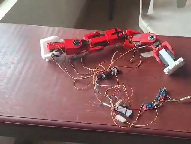 The seven-joint PAAMB snake robot performing its serpentine gait — real hardware